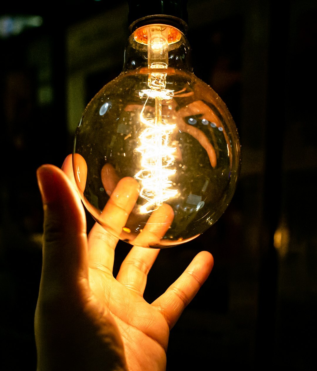 Lightbulb held in hand representing ideas
